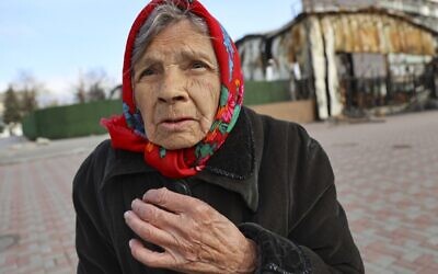 An elderly local resident speaks to a journalist near a destroyed part of the Illich Iron & Steel Works Metallurgical Plant, the second largest metallurgical enterprise in Ukraine, in an area controlled by Russian-backed separatist forces in Mariupol, Ukraine, April 16, 2022. (AP Photo/Alexei Alexandrov)