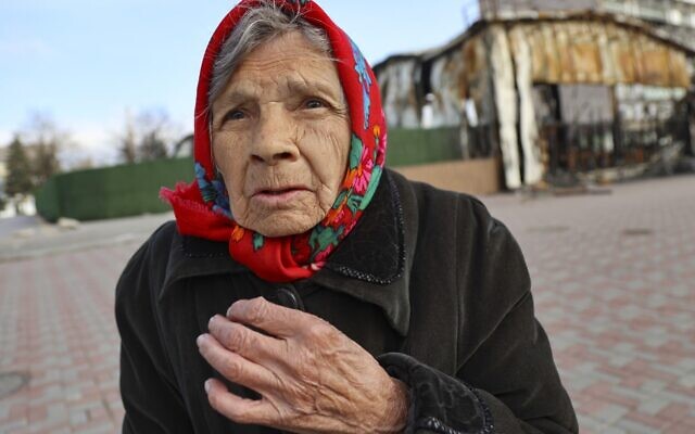 An elderly local resident speaks to a journalist near a destroyed part of the Illich Iron & Steel Works Metallurgical Plant, the second largest metallurgical enterprise in Ukraine, in an area controlled by Russian-backed separatist forces in Mariupol, Ukraine, April 16, 2022. (AP Photo/Alexei Alexandrov)