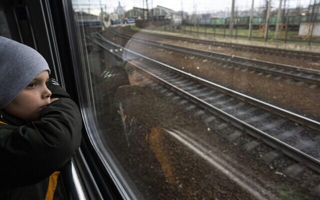 Sergei looks out of the window of a train minutes before arriving with his family in Lviv, from Kyiv, Ukraine, April 17, 2022. (AP Photo/Rodrigo Abd)