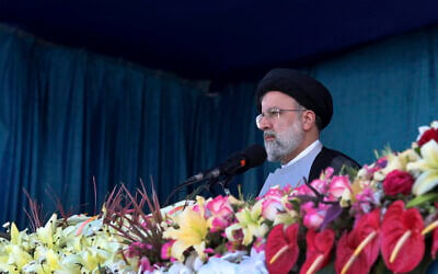 Iran's President Ebrahim Raisi reviews the army troops parade commemorating National Army Day in front of the mausoleum of the late revolutionary founder Ayatollah Khomeini, outside Tehran, Iran, April 18, 2022. (Iranian Presidency Office via AP)