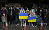 People hold Ukrainian flags in front of the Ukrainian Embassy to show their support for the people of Ukraine after Russian invaded Ukraine, in Tehran, Iran, on February 26, 2022. (AP Photo, File)