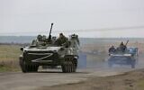 Russian military vehicles move on a highway in an area controlled by Russian-backed separatist forces near Mariupol, Ukraine, on April 18, 2022. (AP Photo/Alexei Alexandrov)