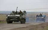Russian military vehicles move on a highway in an area controlled by Russian-backed separatist forces near Mariupol, Ukraine, on April 18, 2022. (AP Photo/Alexei Alexandrov)
