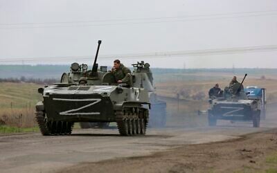 Russian military vehicles move on a highway in an area controlled by Russian-backed separatist forces near Mariupol, Ukraine, on April 18, 2022. (AP Photo/Alexei Alexandrov)