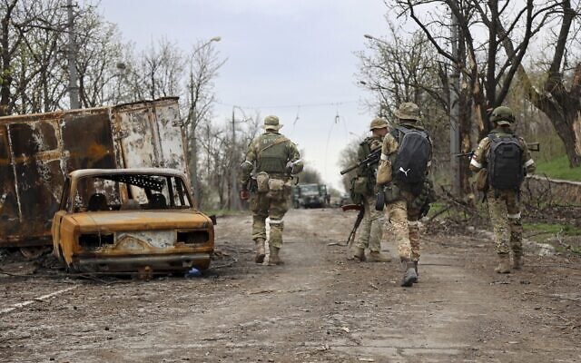 Servicemen of Donetsk People's Republic militia walk past damaged vehicles during heavy fighting in an area controlled by Russian-backed separatist forces in Mariupol, Ukraine, on April 19, 2022. (AP Photo/Alexei Alexandrov) Servicemen of Donetsk People's Republic militia walk past damaged vehicles during heavy fighting in an area controlled by Russian-backed separatist forces in Mariupol, Ukraine, on April 19, 2022. (AP Photo/Alexei Alexandrov)