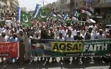 Supporters of Islamic group 'Jamaat-e-Islami' participate in a rally to show solidarity for the Palestinian people following recent clashes with Israeli police, Friday, April 22, 2022, in Karachi, Pakistan. (AP Photo/Fareed Khan)