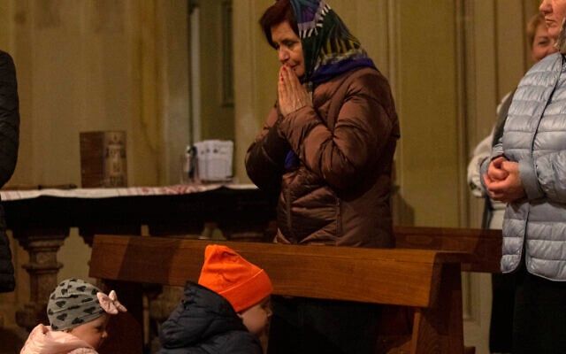 A Ukrainian woman prays during an orthodox Easter service for Ukrainians, both residents and refugees, in Melzo, in the outskirts of Milan, on April 23, 2022. (AP Photo/Alberto Pellaschiar) A Ukrainian woman prays during an orthodox Easter service for Ukrainians, both residents and refugees, in Melzo, in the outskirts of Milan, on April 23, 2022. (AP Photo/Alberto Pellaschiar)