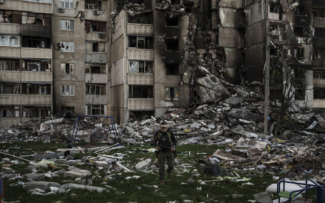 A Ukrainian serviceman walks amid the rubble of a building heavily damaged by multiple Russian bombardments near a frontline in Kharkiv, Ukraine, on April 25, 2022. (AP Photo/Felipe Dana) A Ukrainian serviceman walks amid the rubble of a building heavily damaged by multiple Russian bombardments near a frontline in Kharkiv, Ukraine, on April 25, 2022. (AP Photo/Felipe Dana)