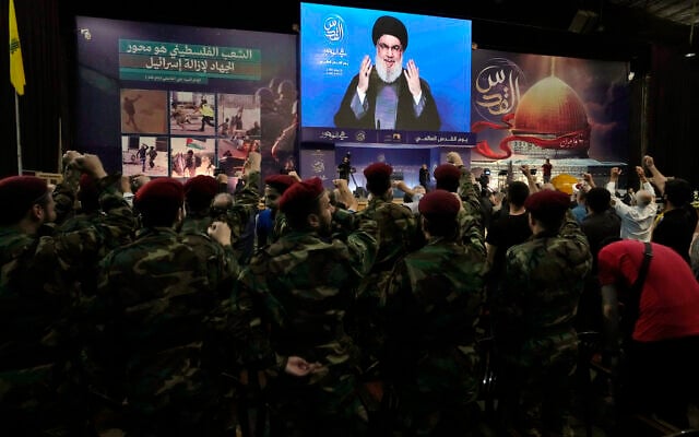 Hezbollah fighters march as they hold flags during a rally to mark Jerusalem day or Al-Quds day, in a southern suburb of Beirut, Lebanon, Friday, April 29, 2022. (AP Photo/Hassan Ammar) Hezbollah fighters march as they hold flags during a rally to mark Jerusalem day or Al-Quds day, in a southern suburb of Beirut, Lebanon, Friday, April 29, 2022. (AP Photo/Hassan Ammar)