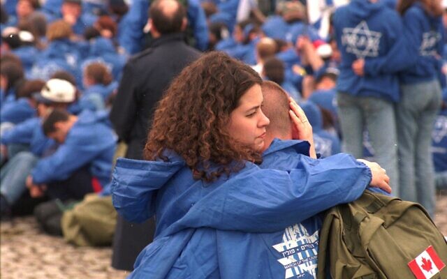 Illustrative: A Canadian Jewish pair comfort each other during a ceremony at the fomer Nazi Death Camp Auschwitz-Birkenau during the March of the Living Sunday May 4,1997. (AP Photo/Czarek Sokolowski) Illustrative: A Canadian Jewish pair comfort each other during a ceremony at the fomer Nazi Death Camp Auschwitz-Birkenau during the March of the Living Sunday May 4,1997. (AP Photo/Czarek Sokolowski)