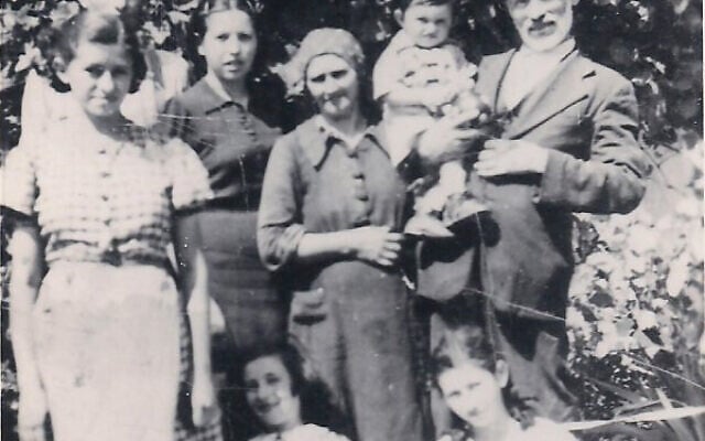Czik family in Ujfeherto, Hungary. Standing (from left): Adele, Shanyi, Bori, mother Lora, father Elek holding daughter Bella's son Asher. Sitting (from left): Eva and Olga. This is the only existing photo of Eva, who died at Bergen-Belsen shortly after liberation. (Courtesy of Olga Czik Kay)