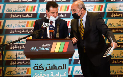 Join List faction leader Ayman Odeh and constituent party leader Ahmad Tibi represent the Joint List during an election event in Nof HaGalil, February 20, 2021. (Roni Ofer/Flash90)