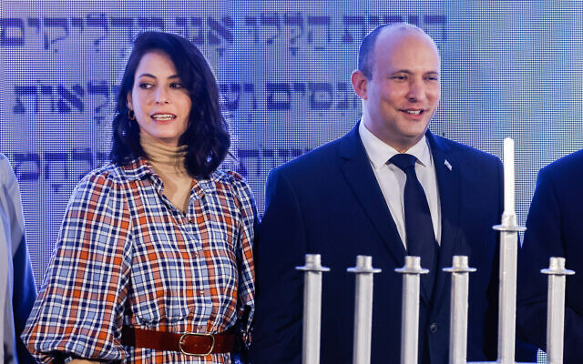 Israeli Prime Minister Naftali Bennett and his wife Gilat attend a ceremony on the second night of the Jewish holiday of Hanukkah, at the Nativ program on the Kiryat Moriah campus in Jerusalem, November 29, 2021. (Olivier Fitoussi/Flash90) Israeli Prime Minister Naftali Bennett and his wife Gilat attend a ceremony on the second night of the Jewish holiday of Hanukkah, at the Nativ program on the Kiryat Moriah campus in Jerusalem, November 29, 2021. (Olivier Fitoussi/Flash90)