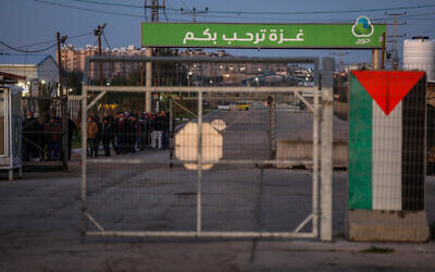 Palestinian workers are seen at the Erez crossing in the northern Gaza Strip, as they wait to enter Israel for work, on March 13, 2022. (Attia Muhammed/Flash90)