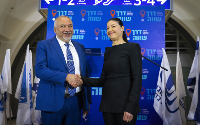 Transportation Minister Merav Michaeli (R) and Finance Minister Avigdor Liberman shake hands during a press conference about a public transportation reform plan, at the Jerusalem railway station on April 3, 2022. (Olivier Fitoussi/Flash90) Transportation Minister Merav Michaeli (R) and Finance Minister Avigdor Liberman shake hands during a press conference about a public transportation reform plan, at the Jerusalem railway station on April 3, 2022. (Olivier Fitoussi/Flash90)