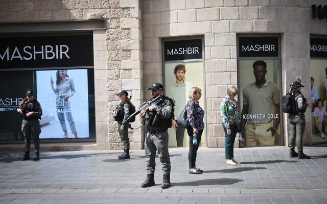 People stand still in Jerusalem, as a two-minute siren is sounded across Israel to mark Holocaust Remembrance Day on April 28, 2022 (Yonatan Sindel/Flash90)