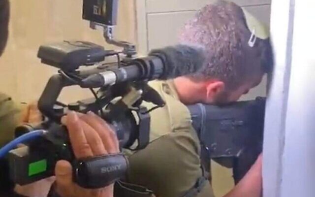 A Channel 12 cameraman and reporter follow an IDF soldier into a home in Tel Aviv during the manhunt for the attacker on April 7, 2022. (Screen capture/Channel 12) A Channel 12 cameraman and reporter follow an IDF soldier into a home in Tel Aviv during the manhunt for the attacker on April 7, 2022. (Screen capture/Channel 12)