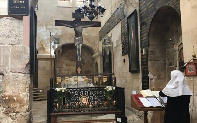 A nun praying in the Alexander Nevsky Church, adjacent to the Church of the Holy Sepulchre, April 11, 2022. (Amanda Borschel-Dan/ Times of Israel) A nun praying in the Alexander Nevsky Church, adjacent to the Church of the Holy Sepulchre, April 11, 2022. (Amanda Borschel-Dan/ Times of Israel)