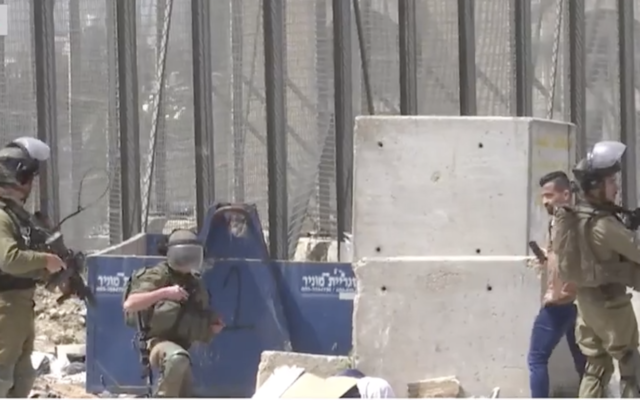 Israeli troops filmed in the aftermath of a shooting incident in Husan in which a Palestinian woman was killed on Sunday, April 10, 2022 (Screenshot/Palestine TV) Israeli troops filmed in the aftermath of a shooting incident in Husan in which a Palestinian woman was killed on Sunday, April 10, 2022 (Screenshot/Palestine TV)