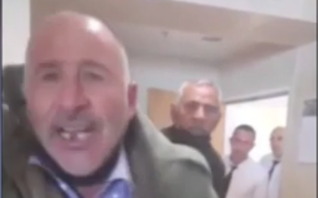Screen capture from video of Khaled Abu Jaudah, whose son was convicted of killing an IDF solider in an terror attack, accosting the father of the victim at the Beersheba District Court, April 27, 2022. (Channel 12 News) Screen capture from video of Khaled Abu Jaudah, whose son was convicted of killing an IDF solider in an terror attack, accosting the father of the victim at the Beersheba District Court, April 27, 2022. (Channel 12 News)