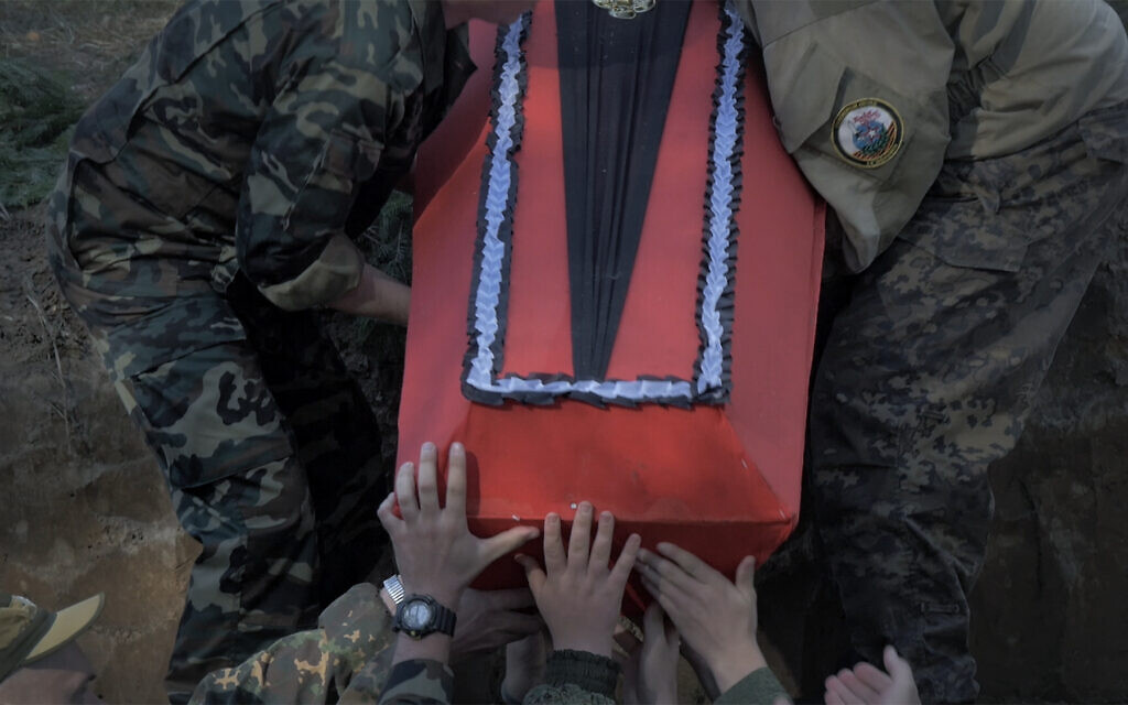 Members of the Russian military bury coffins containing the recovered remains of WWII Russian soldiers in Yelnya, Russia, as seen in Dmitry Bogolyubov's documentary film, 'Town of Glory.' (Courtesy of First Hand Films)