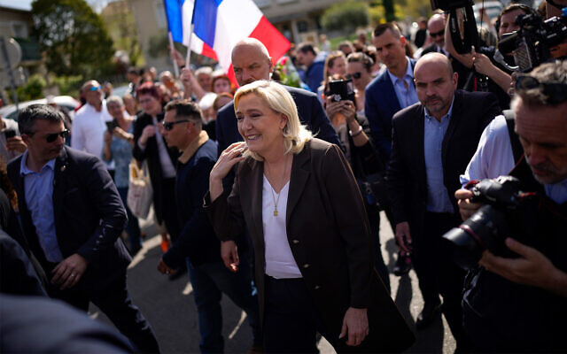 French far-right politician Marine Le Pen, center, arrives during a campaign tour in Pertuis, southern France, April 15, 2022. (AP Photo/Daniel Cole) French far-right politician Marine Le Pen, center, arrives during a campaign tour in Pertuis, southern France, April 15, 2022. (AP Photo/Daniel Cole)