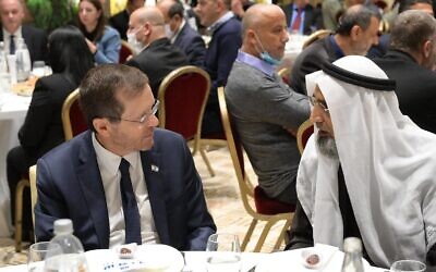President Isaac Herzog (L) speaks with a religious leader at an Iftar dinner hosted at Herzog's official residence, April 13, 2022. (The President's Office)