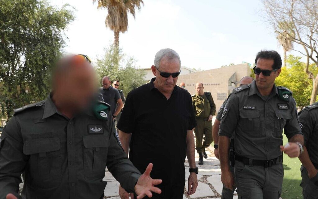 Defense Minister Benny Gantz, center, tours a Border Police base in the West Bank, with the commander of the Border Police, Amir Cohen, right, on April 19, 2022. (Elad Malka/Defense Ministry)
