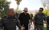 Defense Minister Benny Gantz, center, tours a Border Police base in the West Bank, with the commander of the Border Police, Amir Cohen, right, on April 19, 2022. (Elad Malka/Defense Ministry)