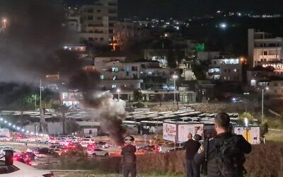 Police officers are seen during a riot at the entrance of the northern Arab city of Umm al-Fahm, early April 23, 2022. (Israel Police)