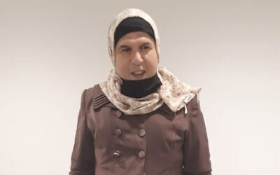 A Jordanian-Palestinian man who dressed up as a woman is detained at the Allenby Bridge border crossing between Israel and the West Bank, on April 30, 2022. (Israel Airports Authority)