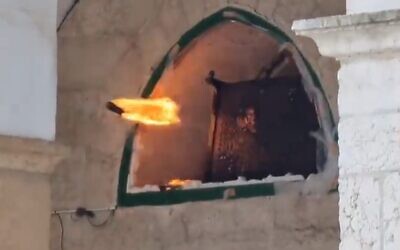 Palestinian rioters throw a Molotov cocktail from inside Al-Aqsa Mosque on the Temple Mount, April 20, 2022 (MFA Twitter screenshot, used in accordance with Clause 27a of the Copyright Law)