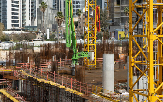 Laborers work at a construction site for a modern skyscraper in Tel Aviv, Israel. Illustrative, April 2022 (Roman Mykhalchuk via iStock by Getty Images) Laborers work at a construction site for a modern skyscraper in Tel Aviv, Israel. Illustrative, April 2022 (Roman Mykhalchuk via iStock by Getty Images)