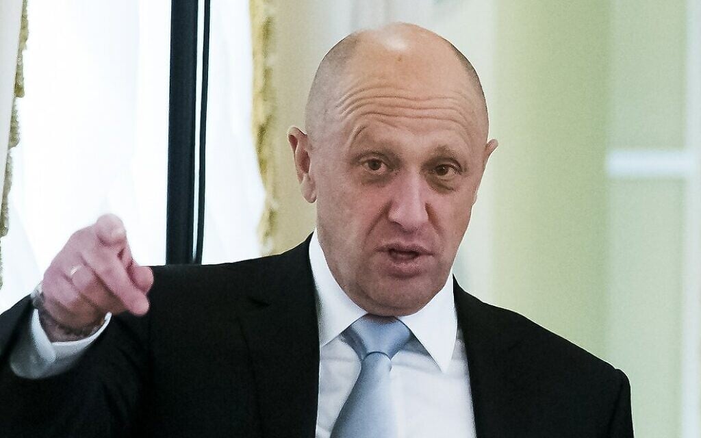 In this Tuesday, Aug. 9, 2016 file photo, businessman Yevgeny Prigozhin, left, gestures on the sidelines of a summit meeting between Russian President Vladimir Putin and Turkish President Recep Tayyip Erdogan at the Konstantin palace outside St. Petersburg, Russia. (AP Photo/Alexander Zemlianichenko, file)