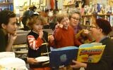 Author Elisabeth Kushner reads 'The Purim Superhero' at a book-release party at Afikomen Judaica in Berkeley, California, in 2014. (Courtesy: Keshet)