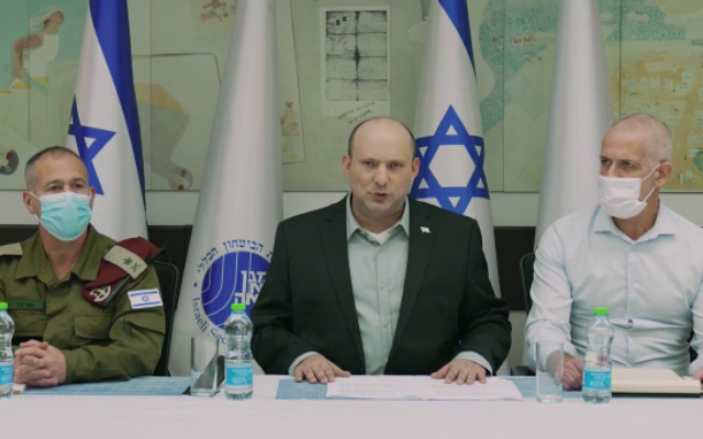 Prime Minister Naftali Bennett (C) speaks in a video statement before a meeting with Shin Bet chief Ronen Bar (R), his military secretary Avi Gil and other security officials, on April 2, 2022. (Screen capture/YouTube)