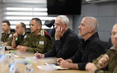 Defense Minister Benny Gantz is seen during a meeting at the IDF Southern Command base in Beersheba, alongside military chief Aviv Kohavi (left), and Shin Bet head Ronen Bar (right), among other officials, April 24, 2022. (Elad Malka/Defense Ministry)