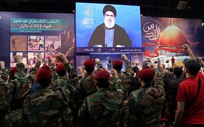 Hezbollah leader Hassan Nasrallah delivers a speech via video during a gathering to mark al-Quds Day in the southern suburb of Lebanon's capital Beirut on April 29, 2022. (Anwar Amro/AFP)
