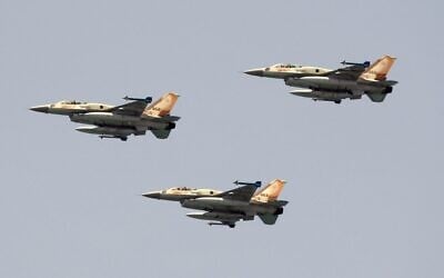 Israeli F-16 fighter jets fly over a beach in Tel Aviv during the annual Independence Day flyover, May 5, 2022. (Jack Guez/AFP)