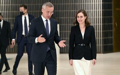 In this photo from October 25, 2021, NATO Secretary-General Jens Stoltenberg (L) meets with Finland's Prime Minister Sanna Marin during the The North Atlantic Council's (NAC) visit in Helsinki. (Jussi Nukari/Lehtikuva/AFP)