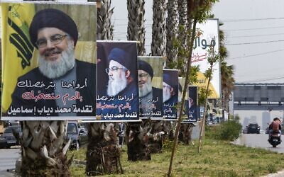 Posters expressing support for the leader of Lebanon's Hezbollah Hassan Nasrallah, hang on a main road in the capital Beirut, on May 14, 2022, on the eve of parliamentary elections. (LOUAI BESHARA / AFP)