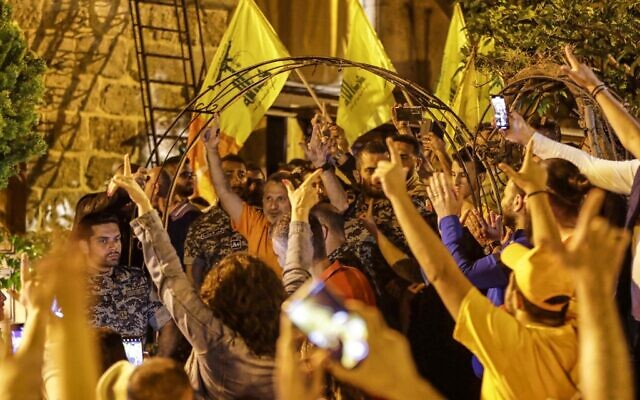 Lebanon's former foreign minister and parliamentary candidate Gibran Bassil (C) meets supporters waving the yellow flags of the Lebanese Hezbollah at his residence after the end of voting in the parliamentary election in the northern city of Batroun early on May 16, 2022. (Ibrahim Chalhoub / AFP) Lebanon's former foreign minister and parliamentary candidate Gibran Bassil (C) meets supporters waving the yellow flags of the Lebanese Hezbollah at his residence after the end of voting in the parliamentary election in the northern city of Batroun early on May 16, 2022. (Ibrahim Chalhoub / AFP)