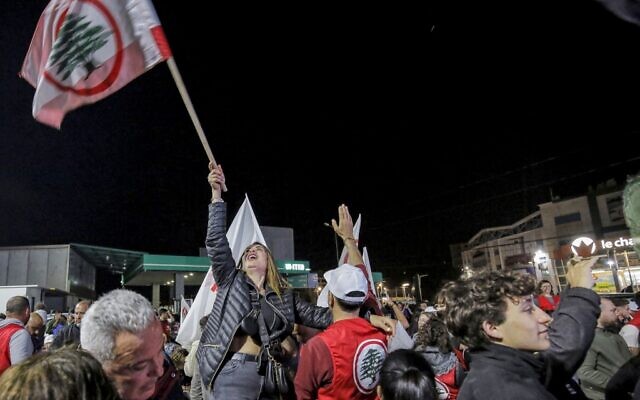 Supporters of the Lebanese Forces party celebrate in the Lebanon's northern coastal city of Batroun as they await results after the end of voting in the parliamentary elections on May 15, 2022. (Ibrahim Chalhoub / AFP) Supporters of the Lebanese Forces party celebrate in the Lebanon's northern coastal city of Batroun as they await results after the end of voting in the parliamentary elections on May 15, 2022. (Ibrahim Chalhoub / AFP)