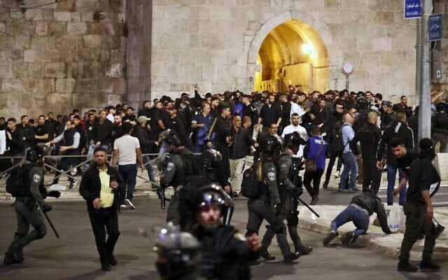 Israeli security forces clash with Palestinians following the funeral of Walid al-Sharif, 23, who died of wounds suffered last month during clashes with Israeli police outside the Al-Aqsa Mosque on the Temple Mount, on May 16, 2022 (Ahmad GHARABLI / AFP)