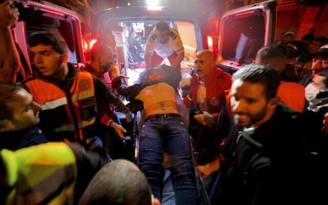 An injured man is evacuated as Israeli security forces clash with Palestinians following the funeral of Walid a-Sharif, 23, who died of wounds suffered last month during clashes with Israeli police at Jerusalem's flashpoint al-Aqsa Mosque on the Temple Mount , on May 16, 2022 outside the Old City of Jerusalem. (AHMAD GHARABLI / AFP) An injured man is evacuated as Israeli security forces clash with Palestinians following the funeral of Walid a-Sharif, 23, who died of wounds suffered last month during clashes with Israeli police at Jerusalem's flashpoint al-Aqsa Mosque on the Temple Mount , on May 16, 2022 outside the Old City of Jerusalem. (AHMAD GHARABLI / AFP)