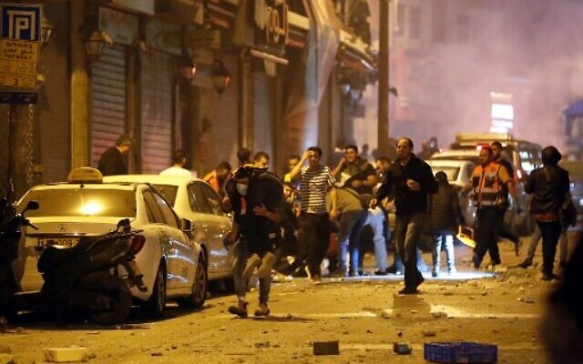 Palestinians clash with Israeli security forces following the funeral of Walid al-Sharif, 23, who died of wounds suffered last month during clashes with Israeli police at Jerusalem's flashpoint al-Aqsa mosque compound, on May 16, 2022 outside the Old City of Jerusalem. - Sharif, 23, was taken to Hadassah Ein Kerem hospital with a "head injury" on April 22 and he was "pronounced dead this morning", the hospital said in a statement. (Photo by Ahmad GHARABLI / AFP) Palestinians clash with Israeli security forces following the funeral of Walid al-Sharif, 23, who died of wounds suffered last month during clashes with Israeli police at Jerusalem's flashpoint al-Aqsa mosque compound, on May 16, 2022 outside the Old City of Jerusalem. - Sharif, 23, was taken to Hadassah Ein Kerem hospital with a "head injury" on April 22 and he was "pronounced dead this morning", the hospital said in a statement. (Photo by Ahmad GHARABLI / AFP)