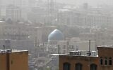 A sandstorm engulfs a mosque in Iran's capital Tehran on May 17, 2022. (AFP)