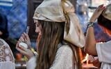 A Jewish pilgrim writes her wishes on an egg before putting it back in the cave at the Ghriba synagogue in Tunisia's southern resort island of Djerba on May 18, 2022, during the annual Jewish pilgrimage to the synagogue. (FETHI BELAID / AFP)