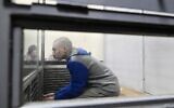 Russian soldier Vadim Shishimarin sits in the defendant's box at the opening of his trial on a charge of war crimes for having killed a civilian, in the Solomyansky district court in Kyiv on May 18, 2022. (AFP/Genya SAVILOV)