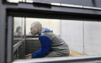 Russian soldier Vadim Shishimarin sits in the defendant's box at the opening of his trial on a charge of war crimes for having killed a civilian, in the Solomyansky district court in Kyiv on May 18, 2022. (AFP/Genya SAVILOV)